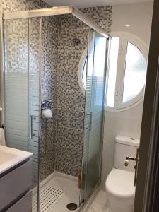 a bathroom with a shower and a toilet at Tamaragua Apartment, Golf del Sur in San Miguel de Abona
