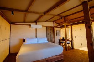 a bedroom with a large bed in a room at Viatura Hacienda Xtojil, Yucatan, Merida, All Inclusive 