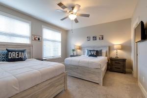 a bedroom with two beds and a ceiling fan at The Celebrity - Minutes to Broadway with a Balcony in Nashville