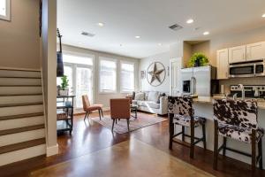 a kitchen and living room with a table and chairs at The Celebrity - Minutes to Broadway with a Balcony in Nashville