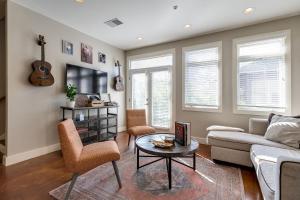a living room with a couch and a table at The Celebrity - Minutes to Broadway with a Balcony in Nashville
