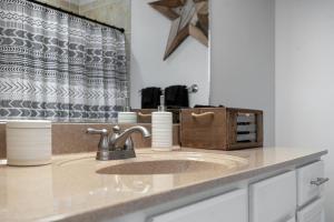 a bathroom counter with a sink and a mirror at The Celebrity - Minutes to Broadway with a Balcony in Nashville +29 photos