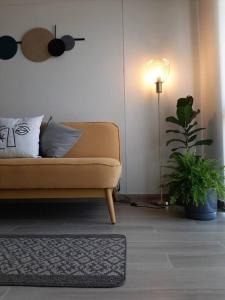 a living room with a couch and a plant at Departamento Familiar en el mirador in Miranda +23 photos