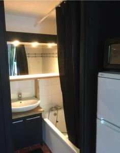 a small bathroom with a sink and a tub and a sink at Charming Mazet ideal for families swimming pool tennis in Maussane-les-Alpilles +7 photos