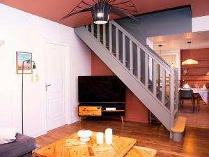 a living room with a staircase and a table at Gîte Déols, 6 pièces, 14 personnes - FR-1-591-167 in Déols