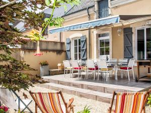 d'une terrasse avec des chaises et des tables. dans l'établissement Gîte Déols, 6 pièces, 14 personnes - FR-1-591-167, à Déols