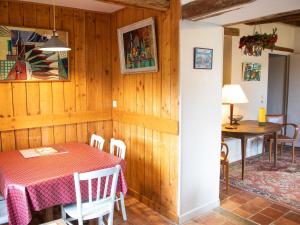 a dining room with a table and a table and chairs at Gîte paisible pour 6 pers. près du zoo de la Flèche, avec jardin, barbecue et WiFi - FR-1-410-126 in Mareil-sur-Loir +4 photos