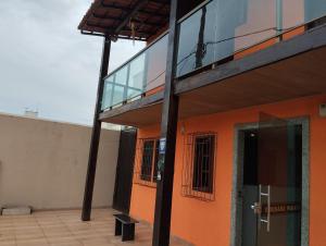 an outside view of a building with a glass door at Hotel Pousada Suites Paraiso - Número 124 in Guarapari