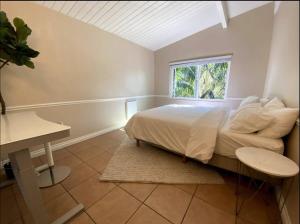 a bedroom with a large bed and a window at West Beach Treehouse in Santa Barbara