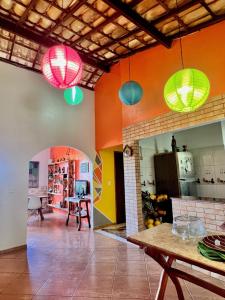 a kitchen with colorful walls and colorful lights at Hospedaria do Tom in Lençóis