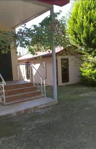 a house with stairs in front of it at Pink house in Lankaran