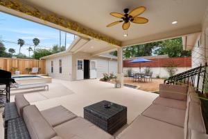a patio with a couch and a ceiling fan at Charming Home in Downtown McAllen in McAllen