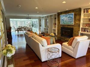 a living room with two white couches and a fireplace at Tara Retreat: Family-Friendly Oasis with Pool, Tennis & Serene Ambiance in Potomac in Potomac