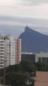 a mountain in the background of a city with buildings at Studio Niterói-Barcas 604 in Niterói