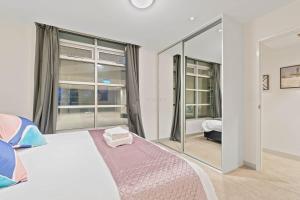a bedroom with a bed and a large mirror at Gouger Chinatown Free parking CBD in Adelaide