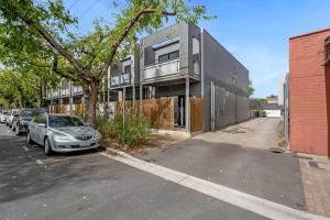 a car parked in a parking lot in front of a building at 2BR Townhouse CBD Chinatown Free WiFi FreeParking in Adelaide