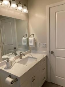 a bathroom with a sink and a large mirror at Bright Napa Home in Napa