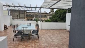 a patio with a table and chairs on a roof at Dpto 4 RaGi in Cordoba