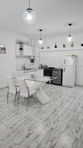 a kitchen with a table and chairs and a refrigerator at Dpto 4 RaGi in Córdoba