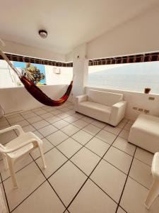 a living room with a hammock in a room at Casa en Punta Barandua in Punta Blanca