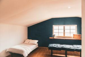 a bedroom with a bed and a window at Casa de praia in Estoril