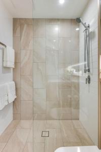 a bathroom with a shower with a glass door at TASTE of African Luxury in the Heart of Brisbane in Brisbane