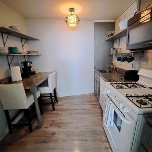 a kitchen with a table and a stove top oven at Heart Downtown! City View Onsite Parking! King Bed LM807 in Atlanta