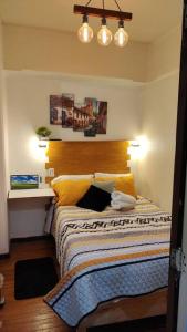 a bedroom with a bed with yellow pillows at Departamento en el centro Histórico CDMX Bolivar 8 Edificio SANTA CLARA in Mexico City
