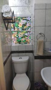 a bathroom with a toilet and a window with flowers at Departamento en el centro Histórico CDMX. in Mexico City