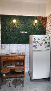 a kitchen with a white refrigerator next to a table at Departamento en el centro Histórico CDMX. in Mexico City