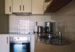 a kitchen with a sink and a counter top at Bay Properties The Seaspray in Yamba