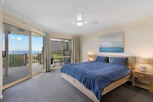 a bedroom with a bed and a balcony at 48 Rumbelow St - BYO Linen - Sea Views - Family Friendly in Encounter Bay