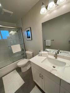 a bathroom with a sink and a toilet and a mirror at Bright Napa Home in Napa