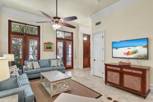 a living room with a couch and a flat screen tv at Le Jardin 154 in Destin