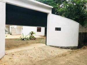 a white building with a large garage door at Shiv's Villa in Galle +4 photos