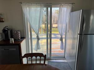 a kitchen with a refrigerator and a sliding glass door at Country House in Catskills in Saugerties +20 photos