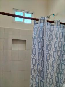 a shower curtain in a bathroom with a window at HOTEL LAS COLORADAS in Yuluc