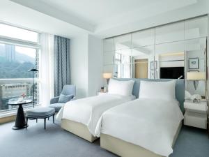 a bedroom with two beds and a large window at Lanson Place Causeway Bay, Hong Kong in Hong Kong