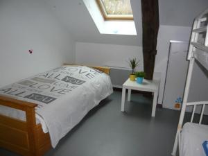 a bedroom with a bed and a table and a window at Gîte spacieux, confort moderne, nature et tranquillité près de Tours et des châteaux de la Loire - FR-1-381-273 in Le Boulay