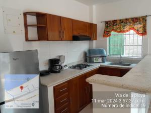 a kitchen with wooden cabinets and a counter top at Apartamento Don Mathias # 1 in Coveñas