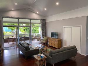 a living room with two couches and a television at Are'ora - the house for living in Rarotonga