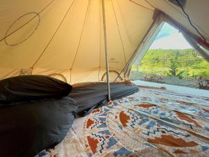 a room with a tent with a bed in it at Lưng Chừng House in Da Lat