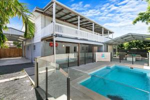 a swimming pool in the backyard of a house at Unwind on Prince in Urangan