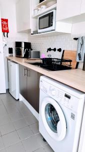 a kitchen with a washing machine in a kitchen at Queen bed apartment- No sharing, your very own space in Quinns Rocks