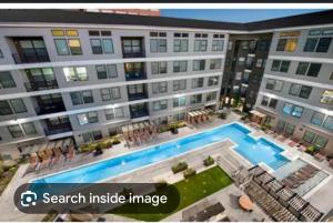 an image of a large apartment building with a swimming pool at Modern luxury retreat! in Atlanta