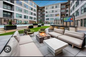 an apartment patio with couches and a fire pit at Modern luxury retreat! in Atlanta