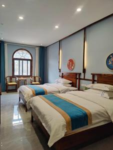 Postel nebo postele na pokoji v ubytování Xinsu Courtyard View GuestHouse