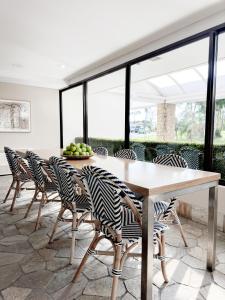 a dining room with a table and chairs at Waves Byron Bay in Byron Bay