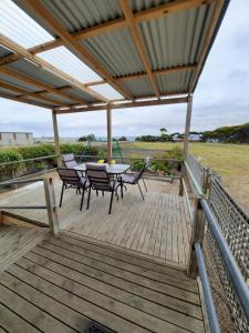 a wooden deck with a table and chairs on it at Kangaroo Island Accommodation in Kingscote