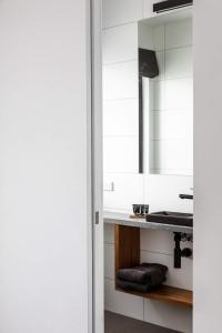 a bathroom with a sink and a mirror at Timber Door Luxury Accommodation Geelong in Geelong
